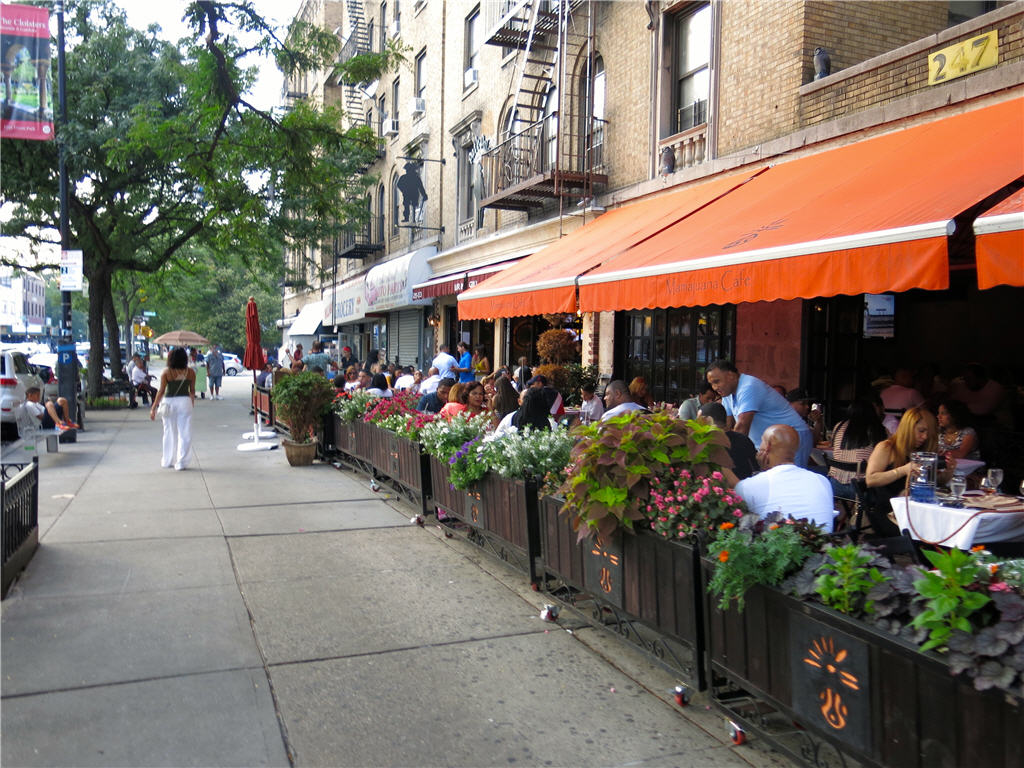 Customers enjoying lunch at Mamajuana Cafe on Tremont Ave, Bronx