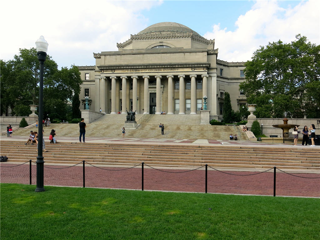 Students relaxing and conversing on the steps of Columbia University Library. 